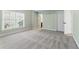 Spacious bedroom with neutral carpet and large window at 2315 Monet Dr, Cumming, GA 30041