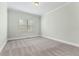 Bright bedroom with neutral carpet, trim and large window at 2315 Monet Dr, Cumming, GA 30041