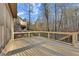 View of spacious deck featuring natural wood and a black metal railing looking to the wooded area at 2315 Monet Dr, Cumming, GA 30041