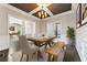 Formal dining room with coffered ceiling, a wooden table with bench, and natural lighting at 2315 Monet Dr, Cumming, GA 30041