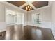 Formal dining room with dark wood flooring, detailed ceiling, chandelier lighting, and large windows at 2315 Monet Dr, Cumming, GA 30041