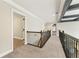 Second-floor hallway with neutral carpet and metal railing at 2315 Monet Dr, Cumming, GA 30041