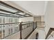 Second-floor hallway featuring neutral carpet, metal railing and coffered ceilings at 2315 Monet Dr, Cumming, GA 30041