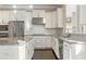 Elegant kitchen with white cabinets, stainless steel appliances, granite counters, and hardwood floors at 2315 Monet Dr, Cumming, GA 30041