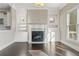 Living area showcasing a fireplace with built-in shelving and natural light from the nearby window at 2315 Monet Dr, Cumming, GA 30041