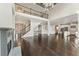 Open-concept living area with hardwood floors, a fireplace, stairs to second floor, and adjacent kitchen at 2315 Monet Dr, Cumming, GA 30041