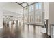 Spacious living area with floor-to-ceiling windows, a fireplace, and gleaming hardwood floors at 2315 Monet Dr, Cumming, GA 30041