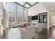 Bright living room with soaring windows, fireplace, built-in bookcases, and stylish decor at 2315 Monet Dr, Cumming, GA 30041