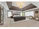 Spacious main bedroom boasts a tray ceiling, neutral tones, and plenty of natural light at 2315 Monet Dr, Cumming, GA 30041