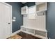 Mudroom features built-in shelving, hooks, a bench, and dark hardwood floors at 2315 Monet Dr, Cumming, GA 30041
