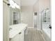 Bright bathroom with a double sink vanity, large mirror, and a shower with marble accents at 2698 Glenrose Hl, Atlanta, GA 30341