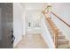 Inviting foyer features tile flooring, a staircase with carpeted steps, and views into a light-filled living area at 2698 Glenrose Hl, Atlanta, GA 30341