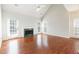 Bright living room with a cozy fireplace, hardwood floors, and ample natural light from multiple windows at 2698 Glenrose Hl, Atlanta, GA 30341