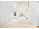 Bright, open-concept living room with soaring ceilings, large windows, and neutral carpeting for versatile decor at 2698 Glenrose Hl, Atlanta, GA 30341