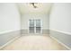 Bright room with neutral walls, plush carpeting, window with blinds, and ample space for customizable use at 2698 Glenrose Hl, Atlanta, GA 30341