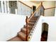 Carpeted staircase with wooden banister and wrought iron spindles leading to the upper level at 3196 Moon Stone Ln, Snellville, GA 30039