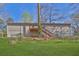 Wide view of backyard with lawn, stairs, and fencing at 3618 Mansfield Ln, Snellville, GA 30039