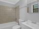 Bright bathroom features a shower-tub combo and a modern vanity at 3618 Mansfield Ln, Snellville, GA 30039