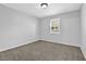 Cozy bedroom with neutral carpet, a window, and fresh gray paint at 3618 Mansfield Ln, Snellville, GA 30039