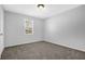 Clean bedroom featuring neutral carpet, a window, and fresh gray paint at 3618 Mansfield Ln, Snellville, GA 30039