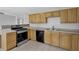Kitchen featuring stainless steel appliances and light wood cabinetry at 3618 Mansfield Ln, Snellville, GA 30039