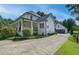 Beautiful white home with a covered porch and a long driveway to a detached garage at 4177 Sardis Church Rd, Buford, GA 30519