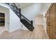 Welcoming foyer with dark wood staircase and modern flooring at 4177 Sardis Church Rd, Buford, GA 30519