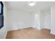 Bedroom featuring a window with black trim, hardwood floors, and two entry doors at 5185 Cascade Rd, Atlanta, GA 30331