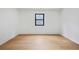 Empty bedroom showcasing hardwood floors, white walls, and natural light from a large window at 5185 Cascade Rd, Atlanta, GA 30331