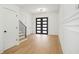 Bright foyer featuring hardwood floors, a modern staircase with iron railings, and elegant lighting fixtures at 5185 Cascade Rd, Atlanta, GA 30331