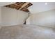 Unfinished basement with stairs leading to upper level and exposed ceiling beams at 585 Lake Dr, Snellville, GA 30039