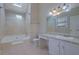 Bathroom with a soaking tub, tile shower, and vanity with storage at 585 Lake Dr, Snellville, GA 30039