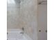 Bright bathroom featuring a soaking tub with travertine tile surround and shower at 585 Lake Dr, Snellville, GA 30039