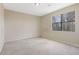 Neutral bedroom features a large window that offers natural light and views of trees at 585 Lake Dr, Snellville, GA 30039