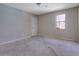 A neutral bedroom with carpet, a window for natural light, and some wear on the walls at 585 Lake Dr, Snellville, GA 30039