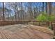 Spacious deck with wooden railings, surrounded by trees and greenery, offers outdoor living space at 585 Lake Dr, Snellville, GA 30039