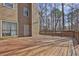 Exterior shot of a wooden deck attached to a house, with trees visible in the background at 585 Lake Dr, Snellville, GA 30039