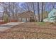 Street view of a two-story home with mature trees, a large driveway and a partially-wooded front yard at 585 Lake Dr, Snellville, GA 30039