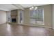 Spacious living room featuring a stone fireplace, ceiling fan, vinyl flooring and natural lighting at 585 Lake Dr, Snellville, GA 30039