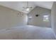 Spacious main bedroom featuring vaulted ceilings, carpet flooring and a ceiling fan at 585 Lake Dr, Snellville, GA 30039
