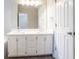Bathroom vanity offering double sinks, ample lighting, and white cabinets at 1202 W Briar Gate Ct, Riverdale, GA 30296