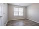 This bright bedroom features a window, neutral paint and durable wood-look flooring at 1202 W Briar Gate Ct, Riverdale, GA 30296