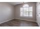 This bright bedroom features a window, neutral paint and durable wood-look flooring at 1202 W Briar Gate Ct, Riverdale, GA 30296