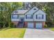 Charming two-story home features a two-car garage, landscaped front yard, and inviting entryway at 1202 W Briar Gate Ct, Riverdale, GA 30296