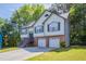 Charming two-story home features a two-car garage, landscaped front yard, and inviting entryway at 1202 W Briar Gate Ct, Riverdale, GA 30296