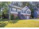 Charming two-story home features a two-car garage, landscaped front yard, and inviting entryway at 1202 W Briar Gate Ct, Riverdale, GA 30296