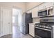 Kitchen featuring stainless steel appliances including a refrigerator, microwave, and range at 1202 W Briar Gate Ct, Riverdale, GA 30296