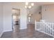 Bright open living room with wood floors, an open layout with kitchen and staircase views at 1202 W Briar Gate Ct, Riverdale, GA 30296