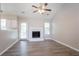 Bright living room with fireplace, ceiling fan, vaulted ceiling, neutral color palette and wood floors at 1202 W Briar Gate Ct, Riverdale, GA 30296