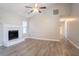 Bright living room features a decorative fireplace, ceiling fan and durable floors at 1202 W Briar Gate Ct, Riverdale, GA 30296